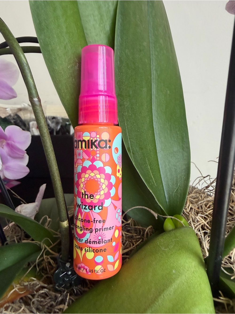 amika Bright Orange Bottle with Pink Cap Detangling Primer